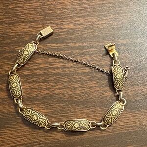 Vintage gold-toned Spanish Damascene panel link bracelet with a safety chain.